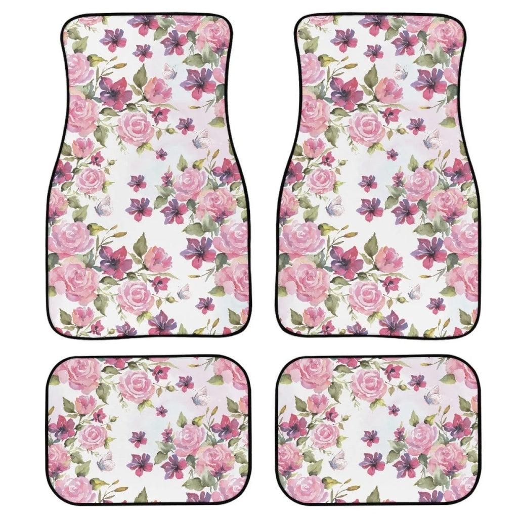 Four-piece set of thick black rubber car floor mats with printed patterns laid out for a vehicle.
