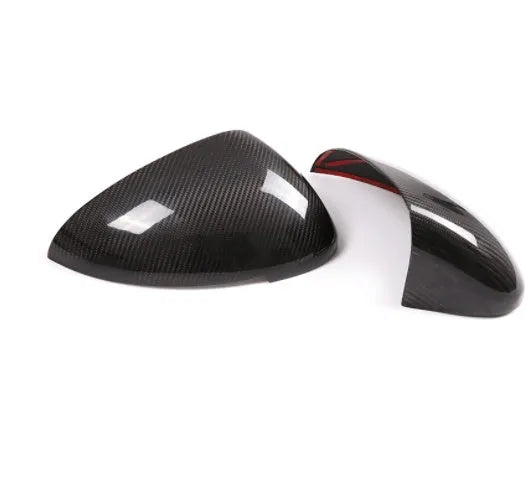 Black true carbon fibre rearview mirror cover for Porsche Macan on a white background