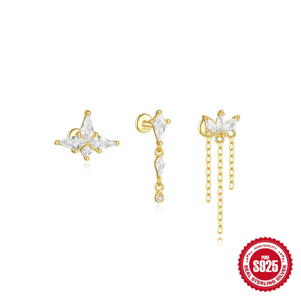 Geometric kite-shaped sterling silver earring with rhinestone head and gold chain tassel.