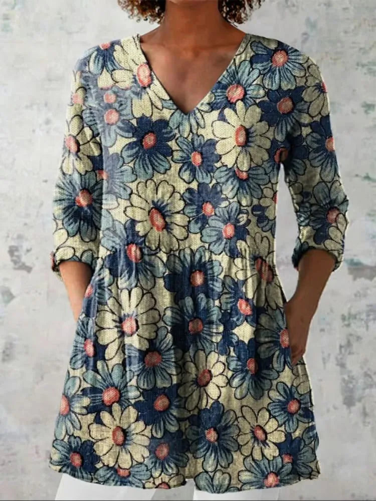 Woman wearing a retro slim fit, digitally printed long-sleeved top in a floral design.
