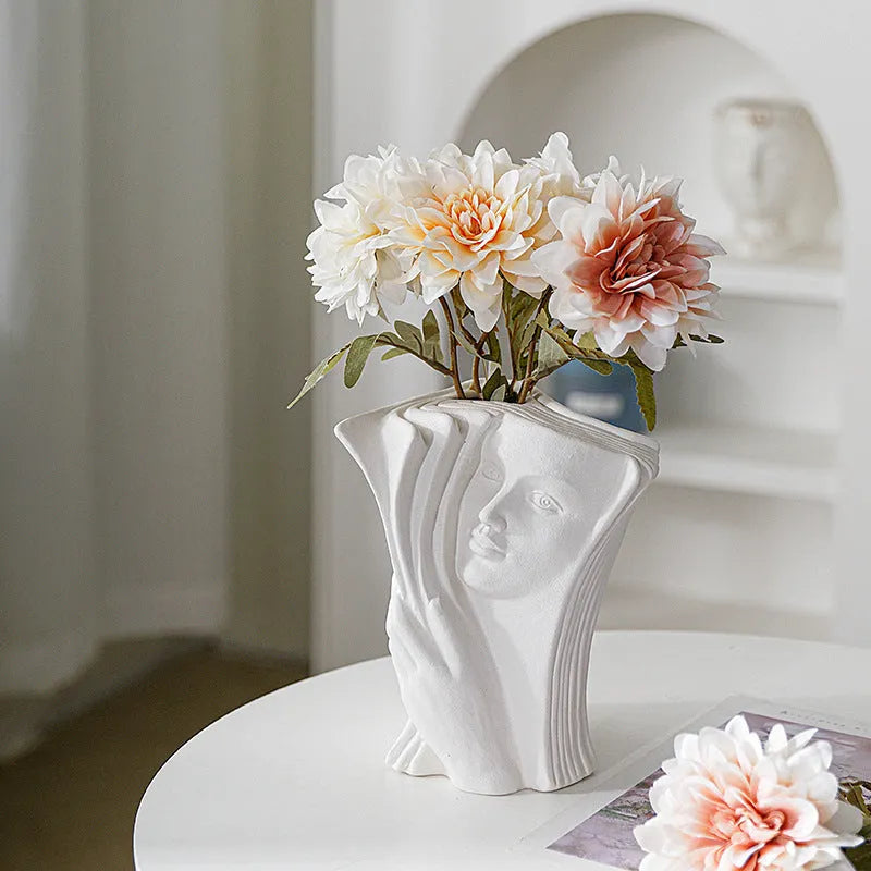 Ceramic book stand with glazed finish in one of four artistic designs on a desk.