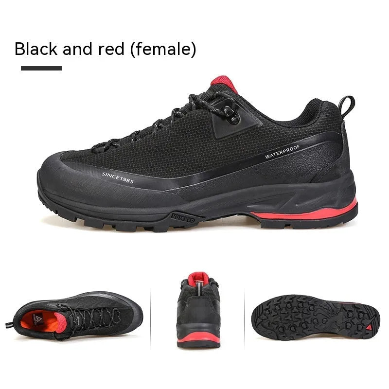 Men's low-top hiking boot in black with front lace-up, rubber outsole, and leather mesh upper.