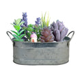Small iron metal flowerpot for succulents on a wooden desktop.