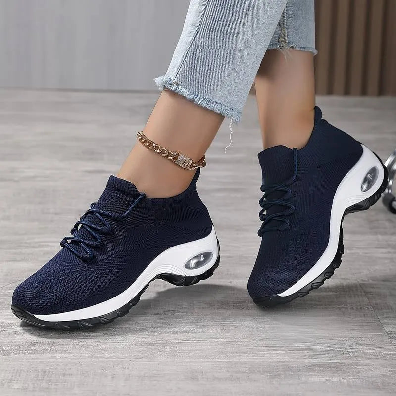 Women's flying knit platform sneakers in black with round toe and waterproof sole