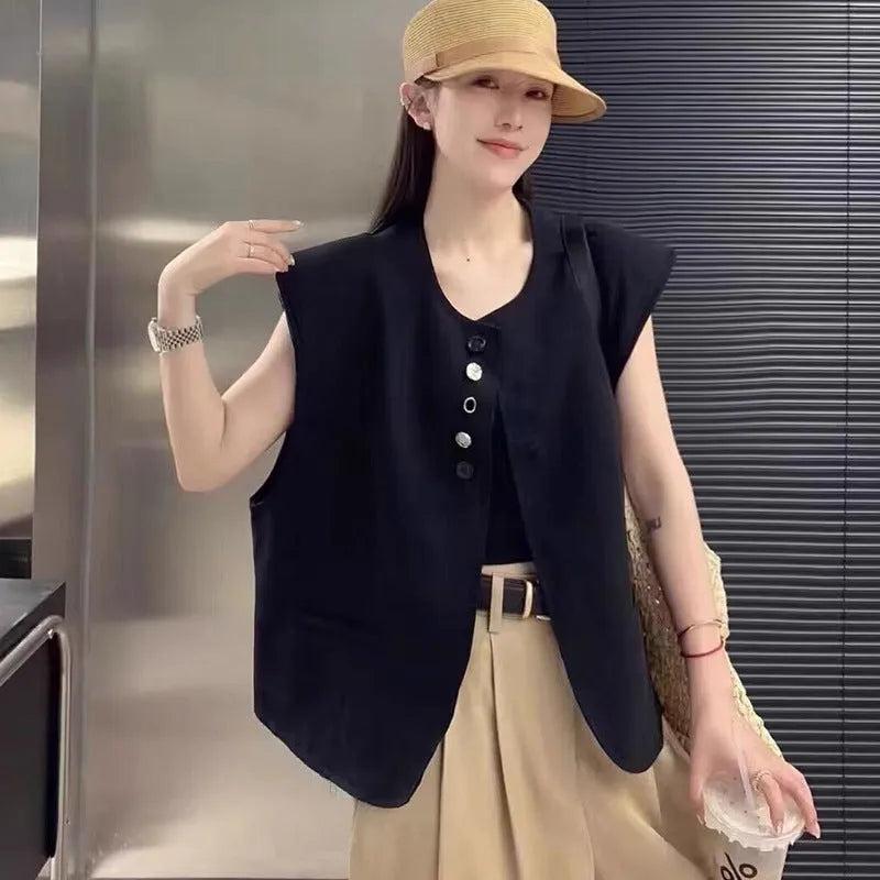 Women's loose-fit short-length polyester vest in milky white colour with front pockets.