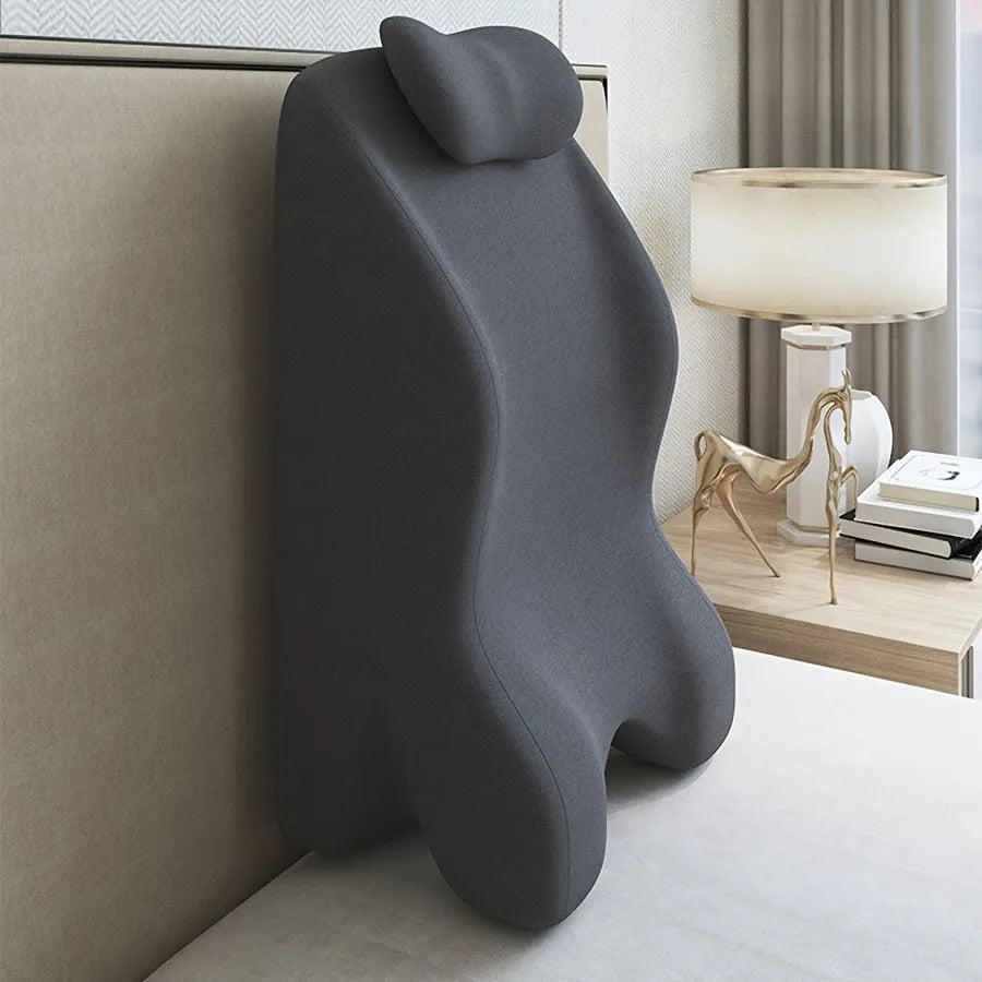Ergonomic stomach sleeper pillow for reading in bed, shown in blue colour