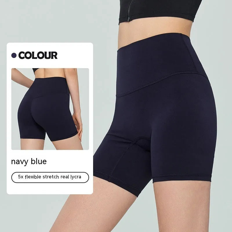 Women's high-waisted Lycra yoga shorts in leaf green, showing anti-exposure construction and short length.