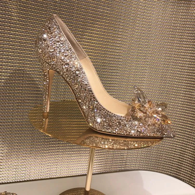 Women's gold pointed toe high heels with rhinestone detail and stiletto heel