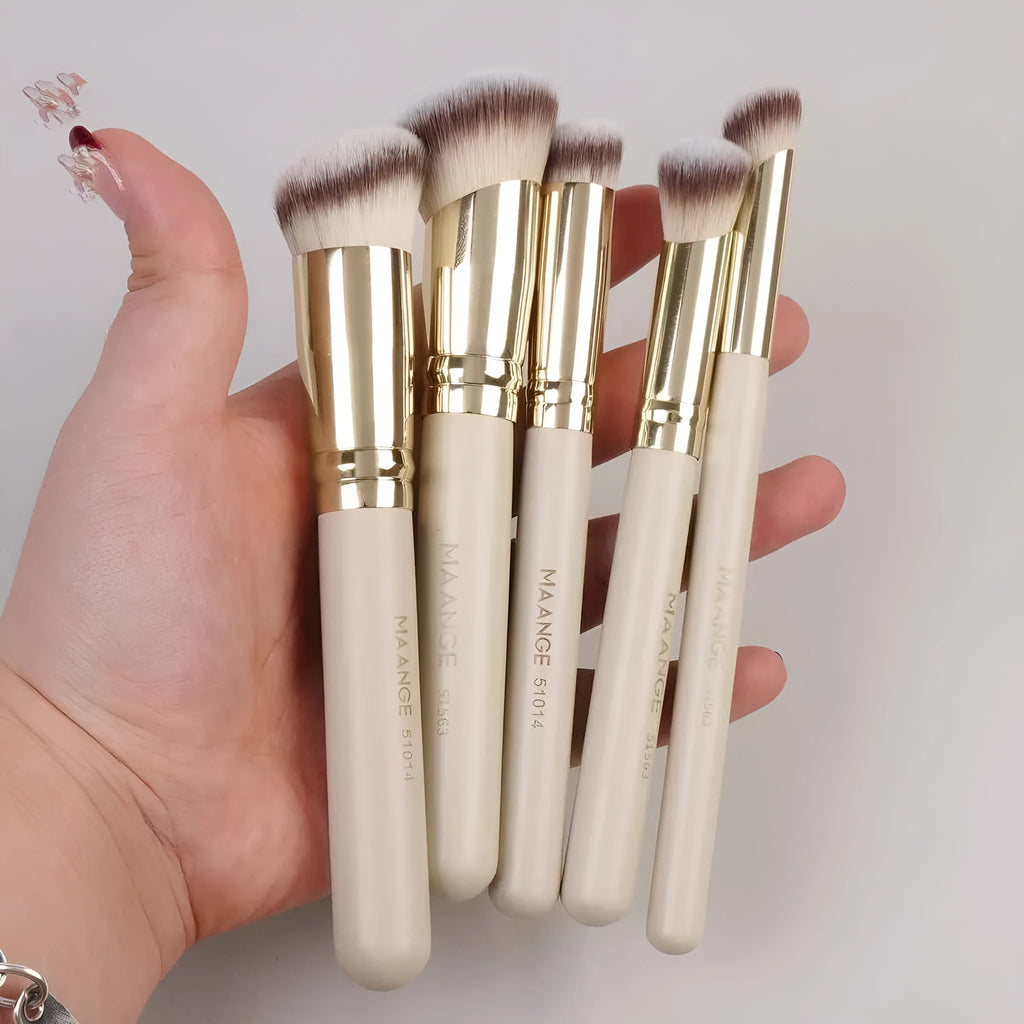 Apricot coloured angled makeup blush brush and four other synthetic brushes from a 5-piece set.