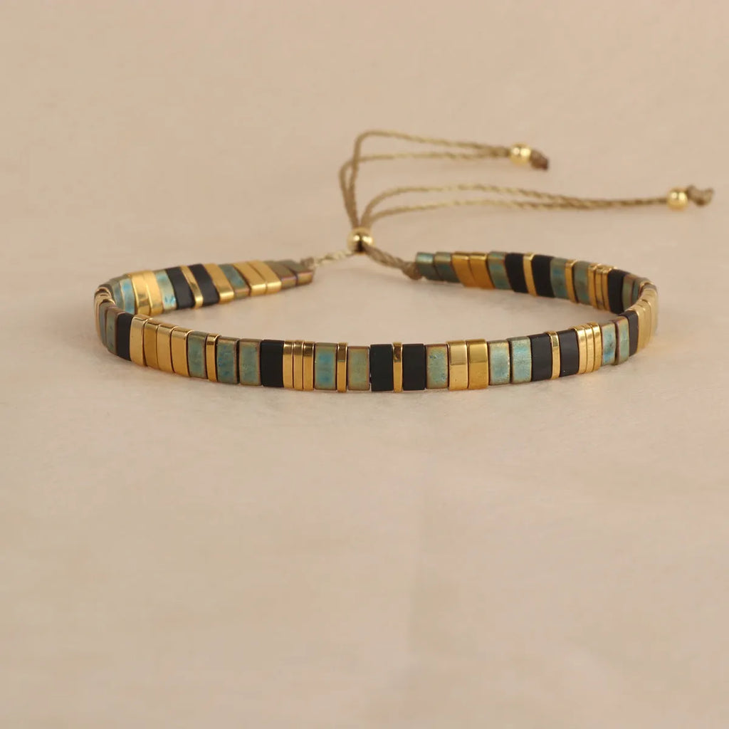 Adjustable pull beads bracelet with glass and coloured glaze beads in geometric and round shapes