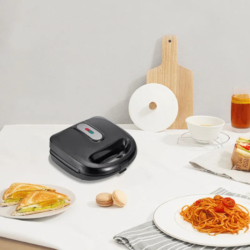 Black electric sandwich toaster with double-sided heating and six non-stick plates on a countertop.