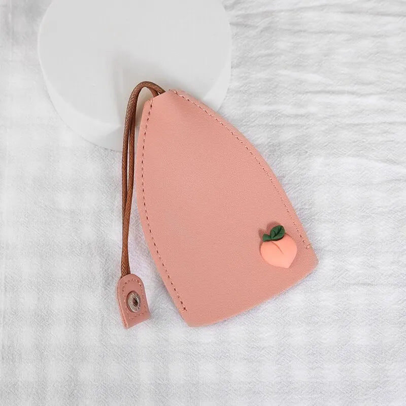 Cartoon pull-out key case in PU leather showing design options including resin fruit and big cartoon animal prints.