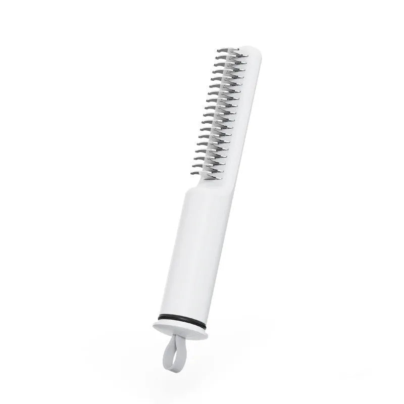 Stainless steel dog dematting comb with ergonomic handle in pink colour on white background