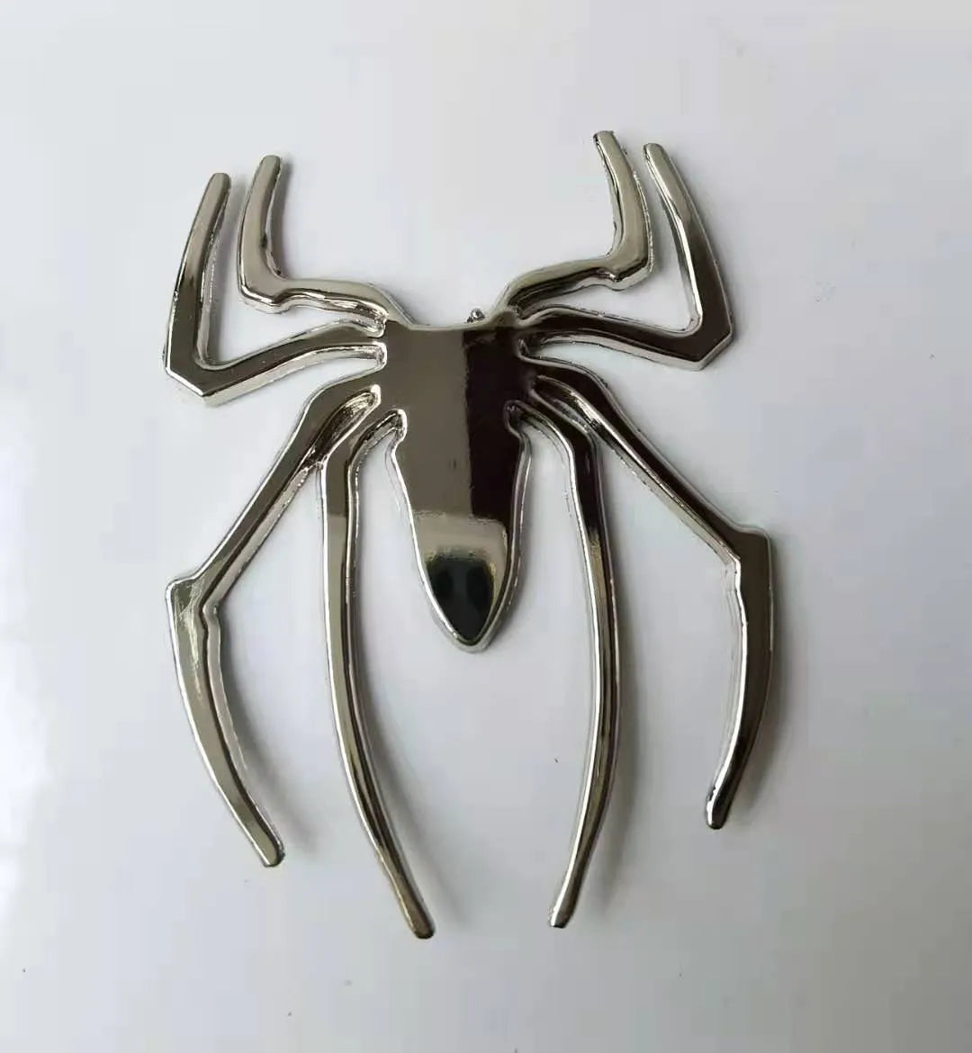 Three-dimensional metal spider sticker in gold colour, measuring 7cm by 5cm.