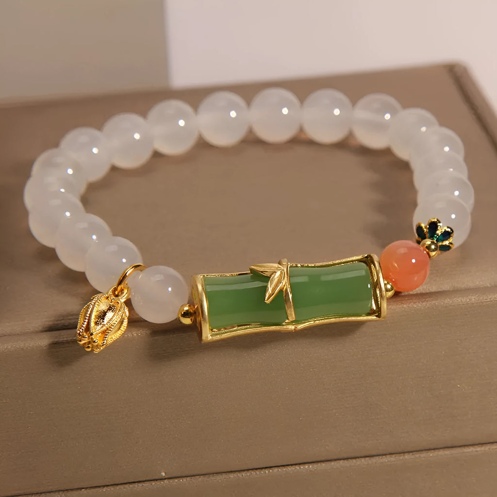 Women's natural style bracelet with jade beads, white agate centrepiece, and bamboo joint detailing.