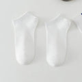 A pair of solid colour low-cut boat socks made from breathable polyester, shown in one of six available colour options.