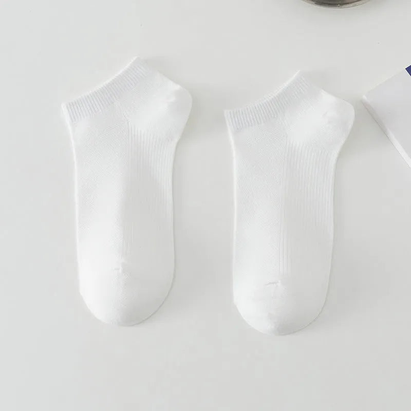 A pair of solid colour low-cut boat socks made from breathable polyester, shown in one of six available colour options.