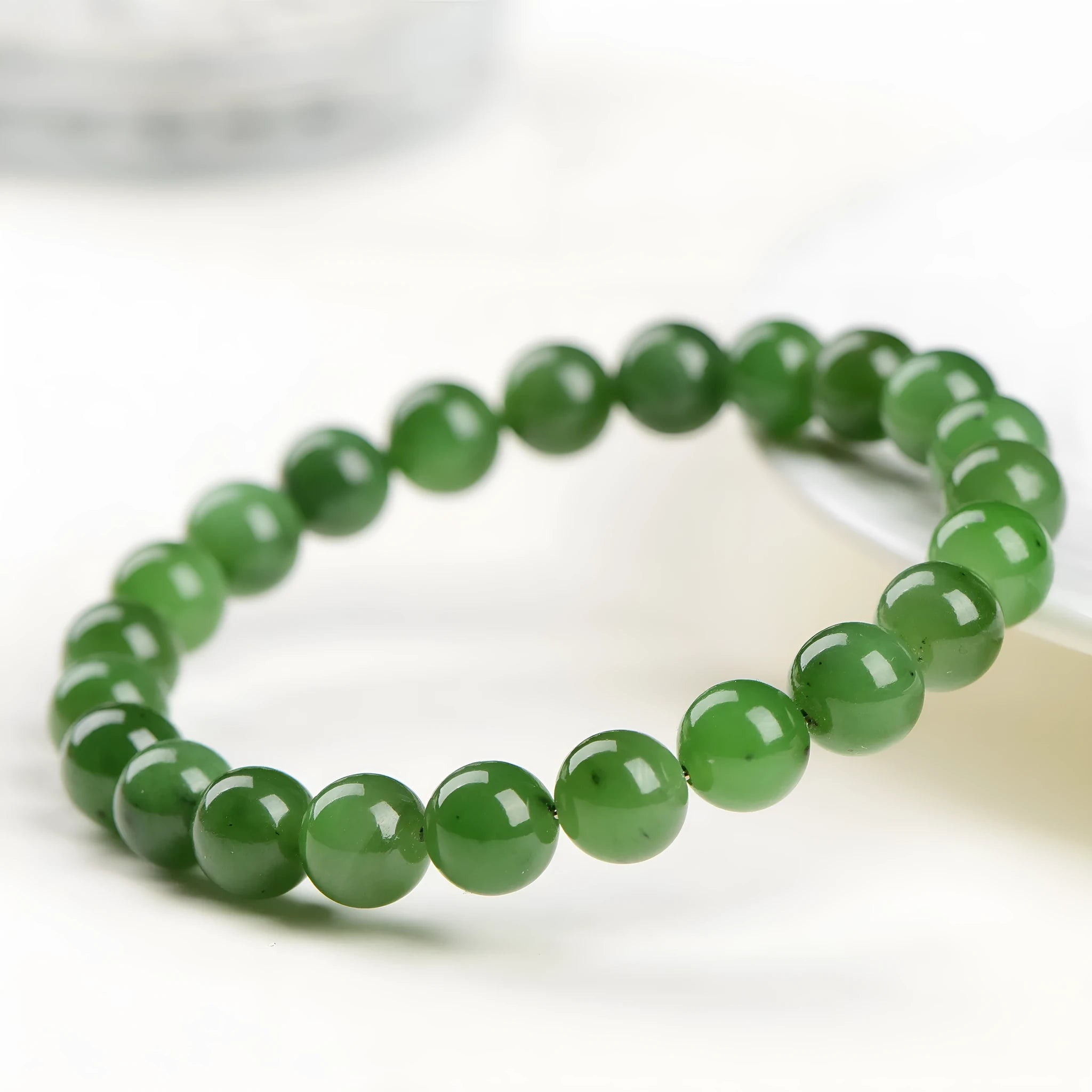 Natural Hetian jade bead bracelet in jasper colours, showing polished beads on a wrist.