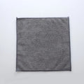 Grey square microfiber kitchen cleaning cloth for oilproof decontamination of pots and bowls.