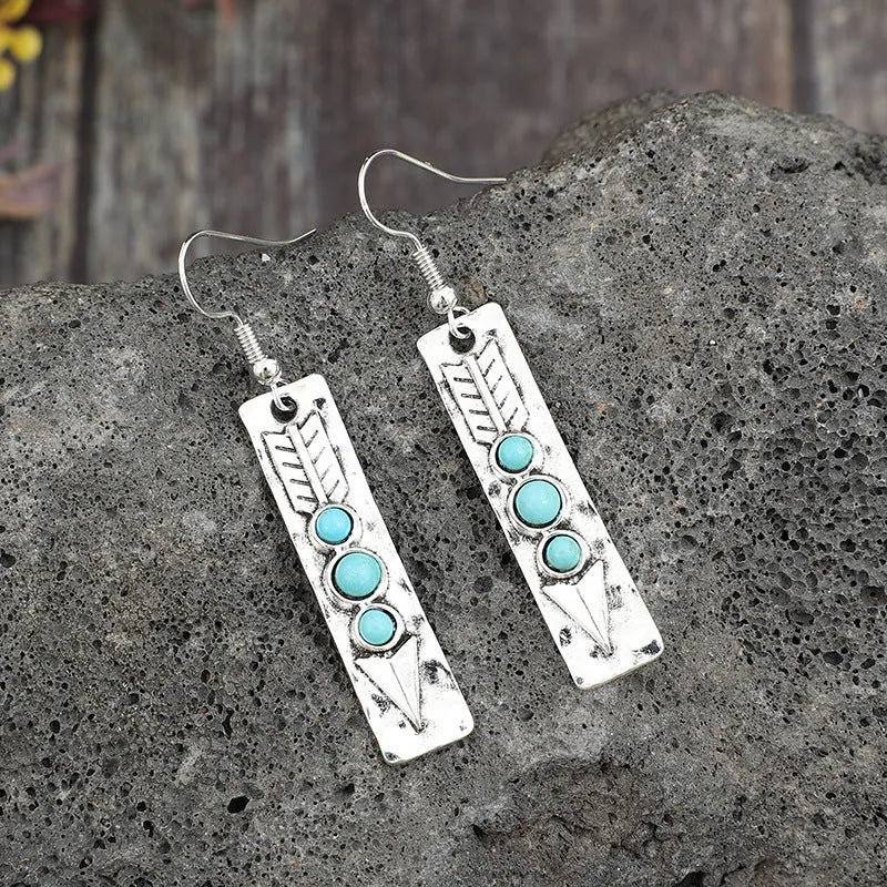 Silver geometric earrings with turquoise inlay on long strip zinc alloy design