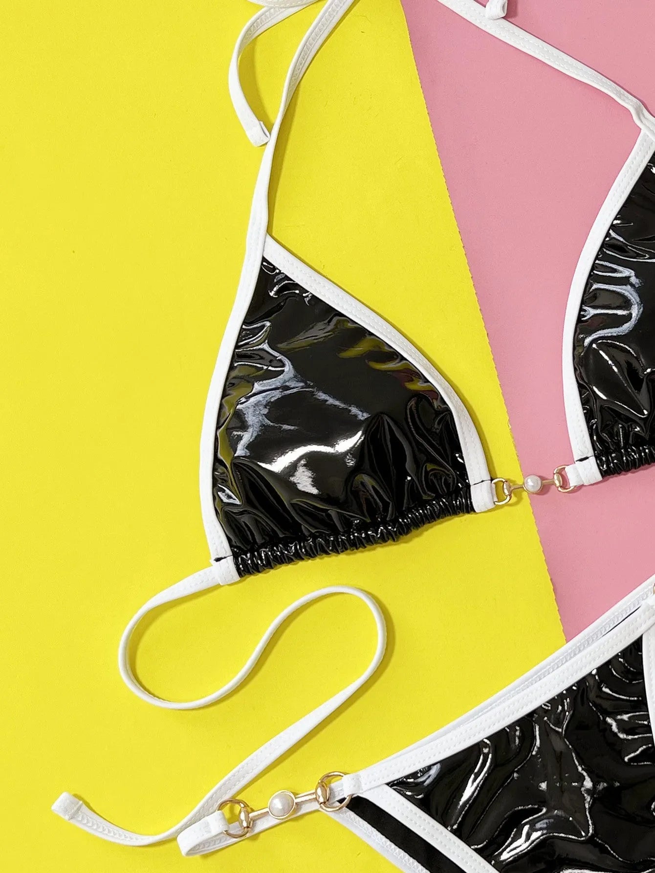 Black solid colour women's two-piece bikini swimsuit with briefs.
