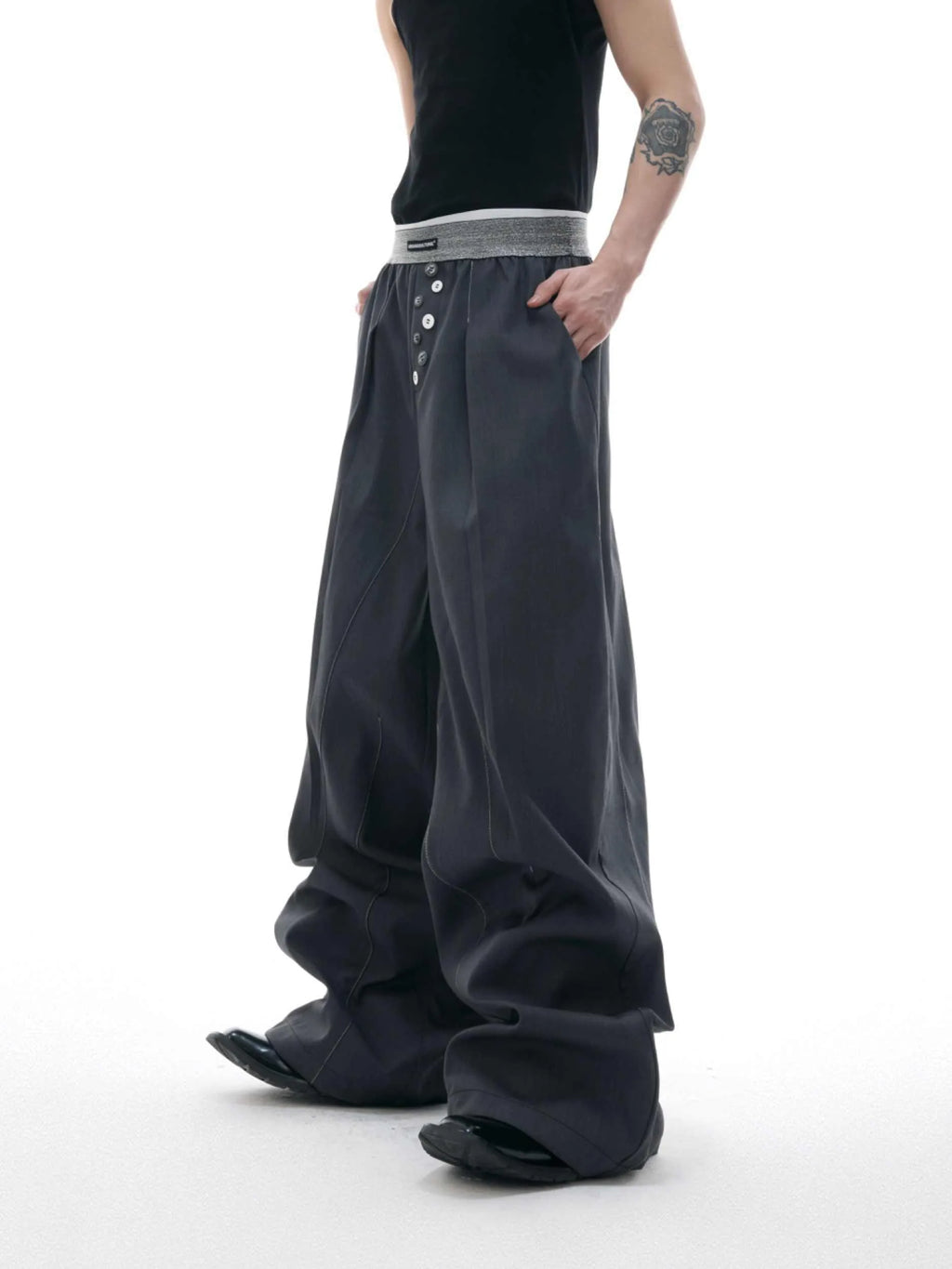 Black straight-leg high-waist trousers with button detail on smart casual model
