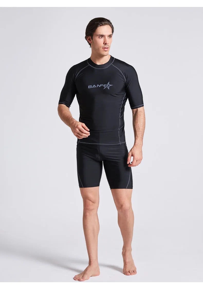 Men's navy blue quick-drying nylon swimsuit set with half-sleeve top and pants for swimming and surfing.