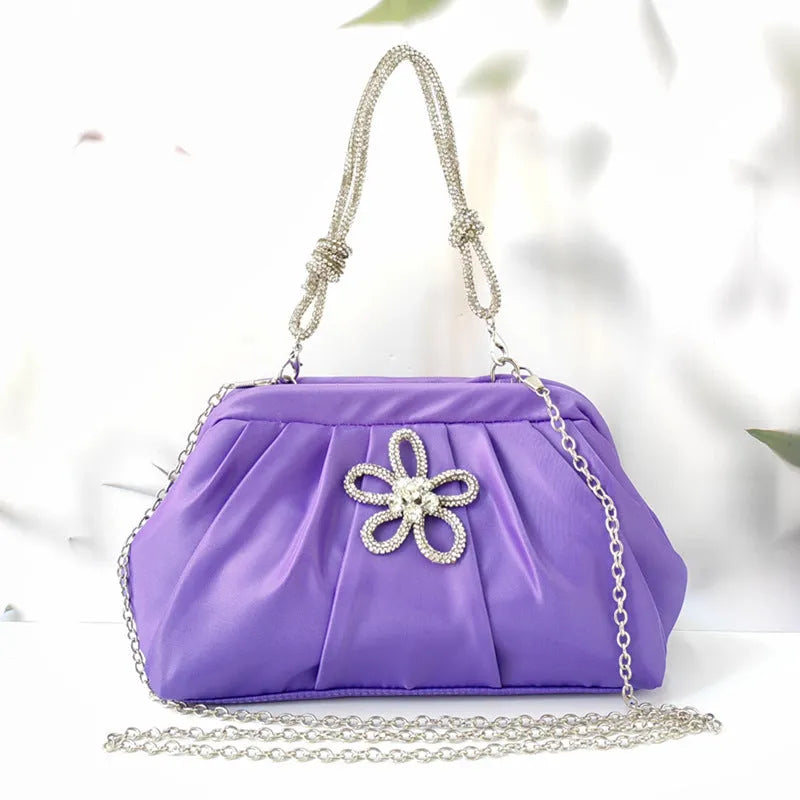 Soft shell-shaped women's large-capacity messenger bag in black, lavender purple, or rose red with fold and chain details.
