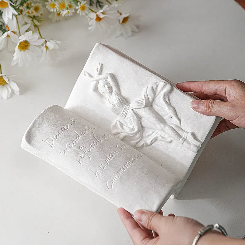Ceramic book stand with glazed finish in one of four artistic designs on a desk.