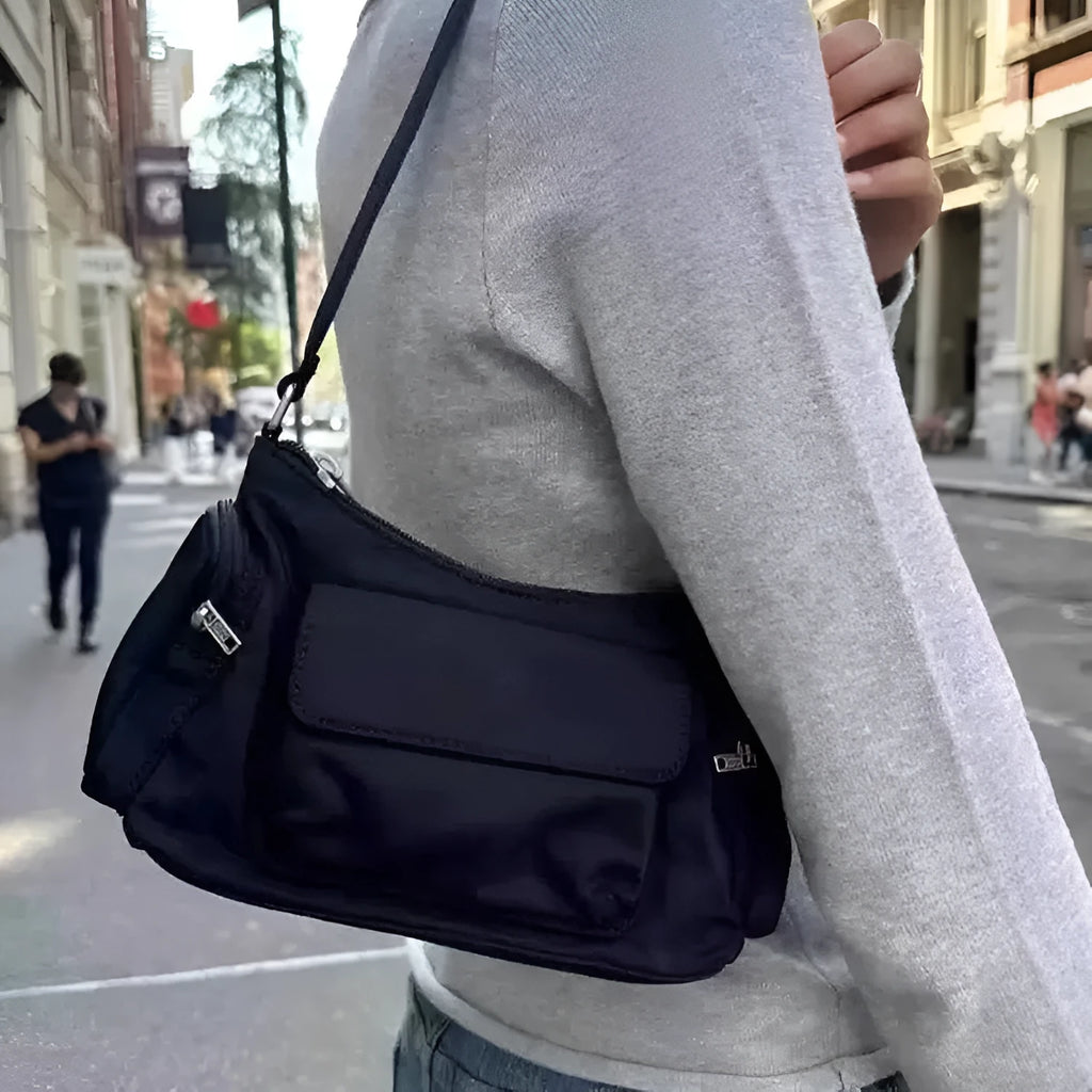 Black PU women's shoulder bag with two pockets, side-line detail, and a nylon lining.