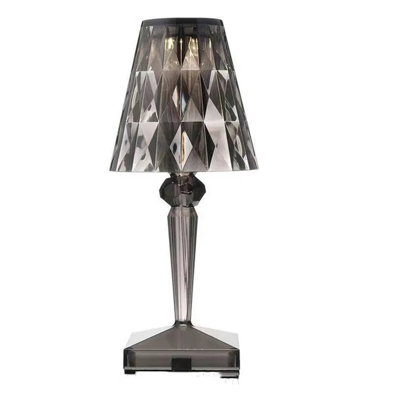 Rose gold portable touch night light with acrylic lamp holder on a surface.