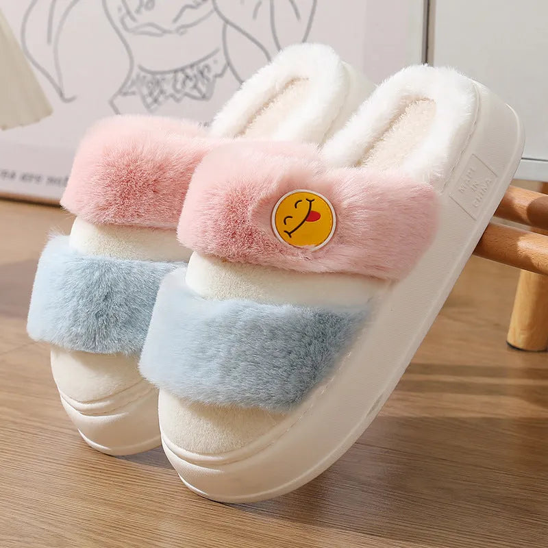 Pink and green thermal cotton slippers with plush upper and non-slip sole.