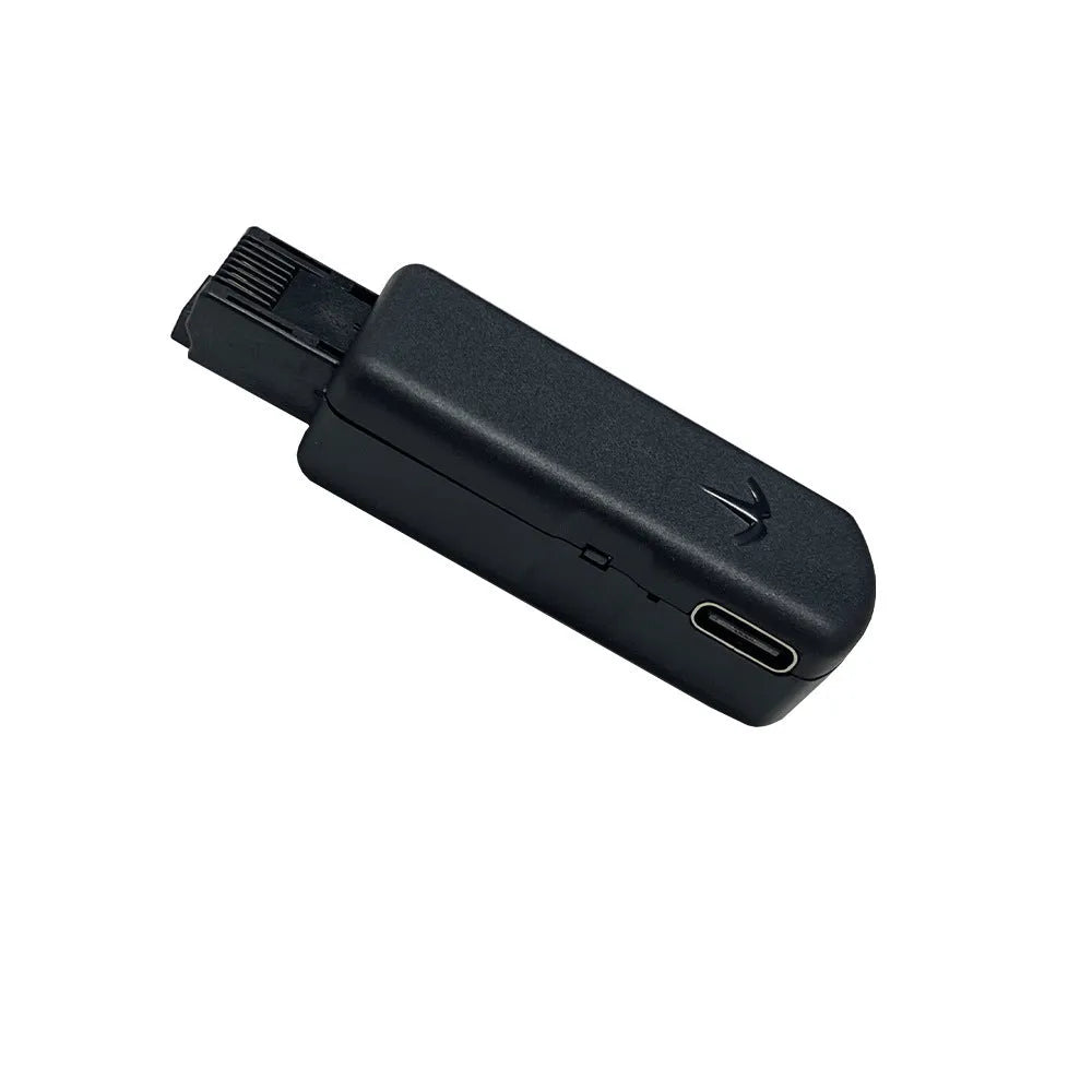 Black JB Tool USB host adapter with aluminum alloy body next to data cable and manual.