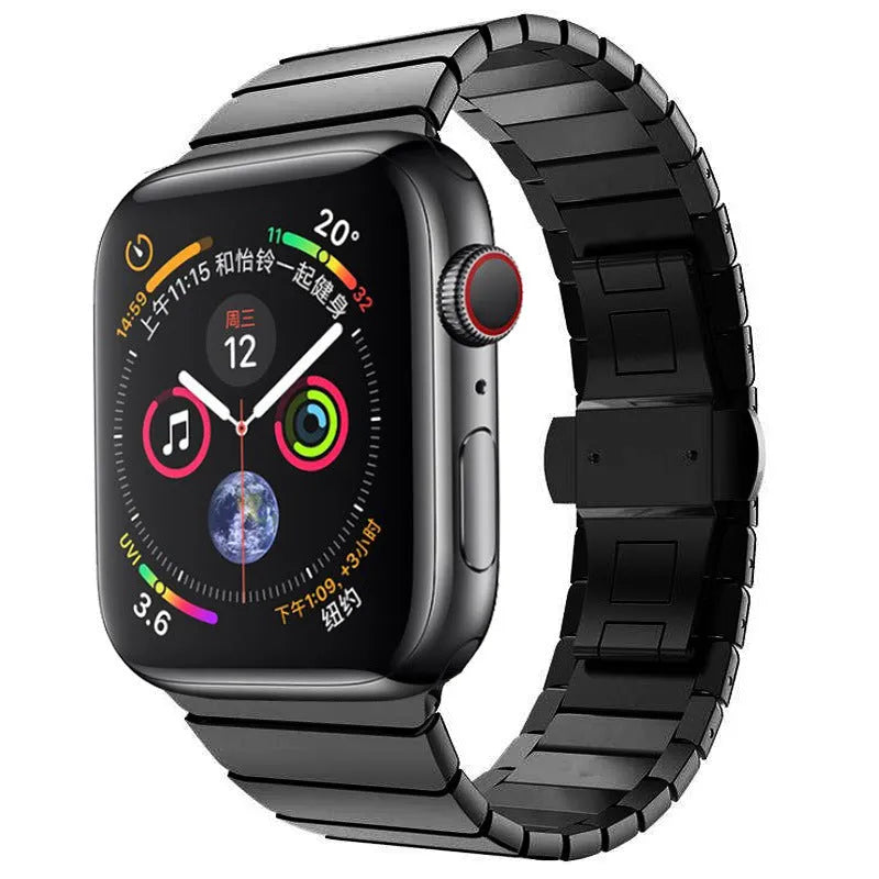 Silver metal Apple Watch strap with butterfly buckle on a wrist, showing the clasp closed.