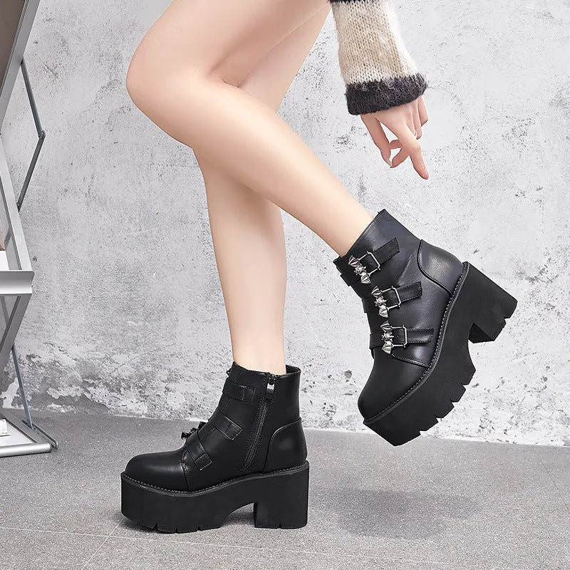 Black women's gothic punk ankle boots with a large bat-shaped buckle and a side zipper.