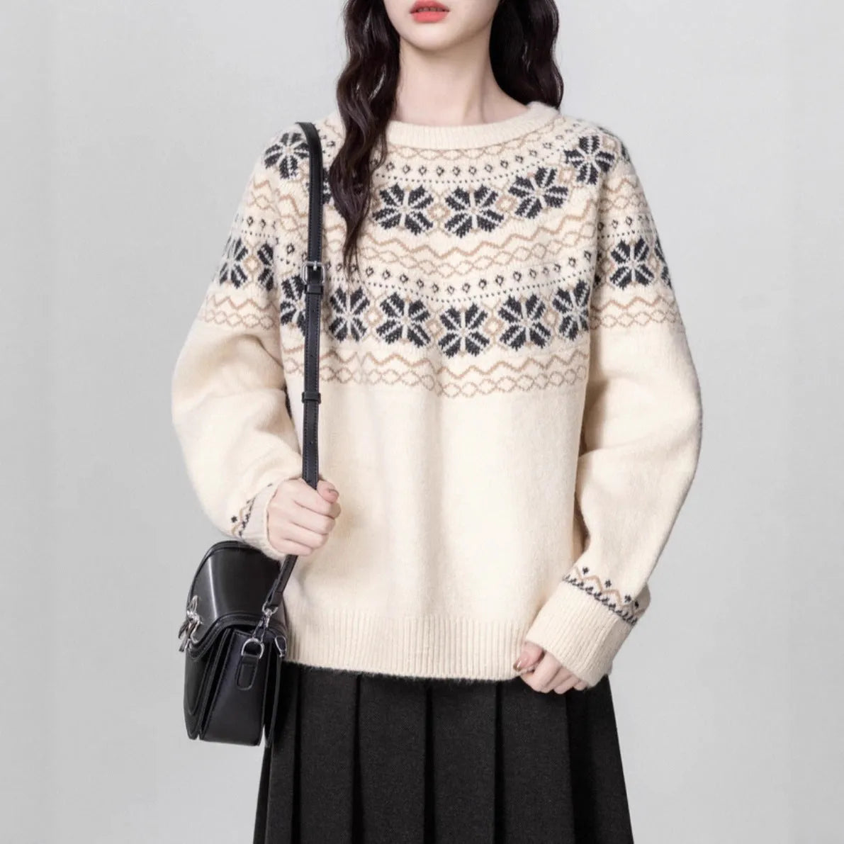 Women's loose-fit Fair Isle pullover sweater with white geometric knit pattern, crew neck, and long sleeves.