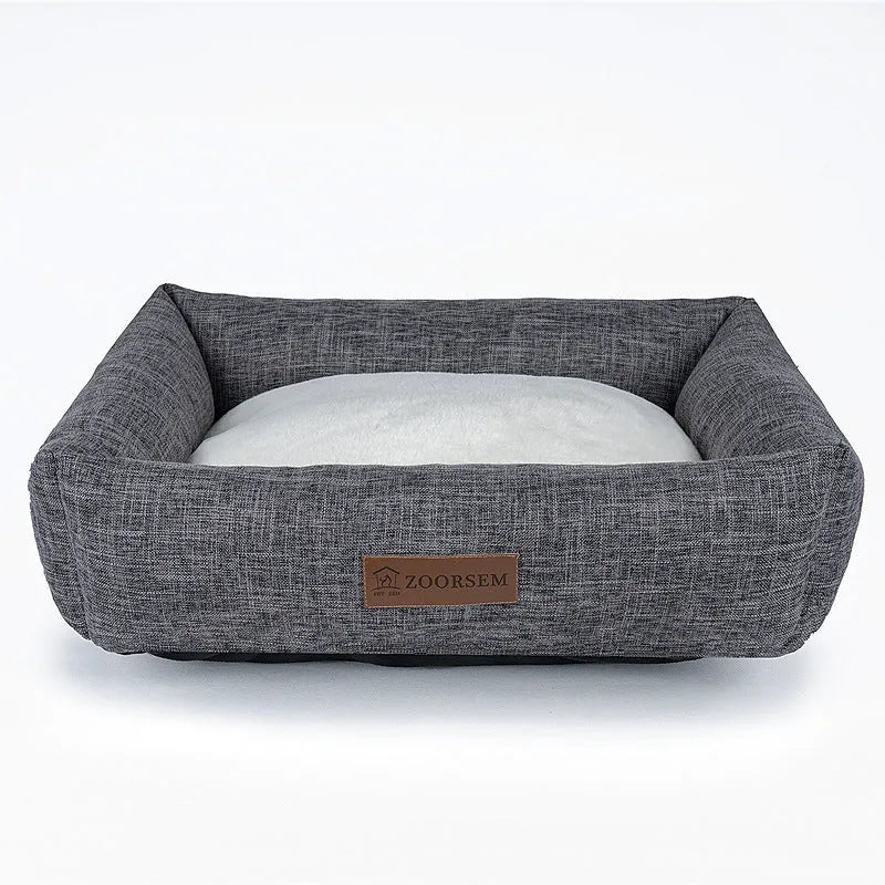 Grey plaid linen square dog bed for medium-sized dogs on a wooden floor.