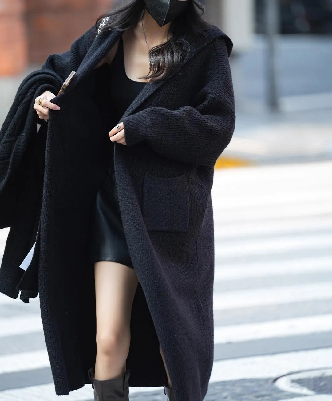 Women's long grey knitted cardigan hooded trench coat on a hanger.