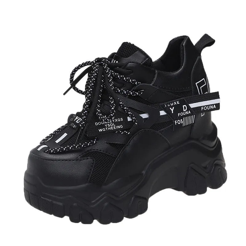 Women's white and black mesh platform sports shoes with cross-strap and rubber sole.