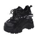 Women's white and black mesh platform sports shoes with cross-strap and rubber sole.