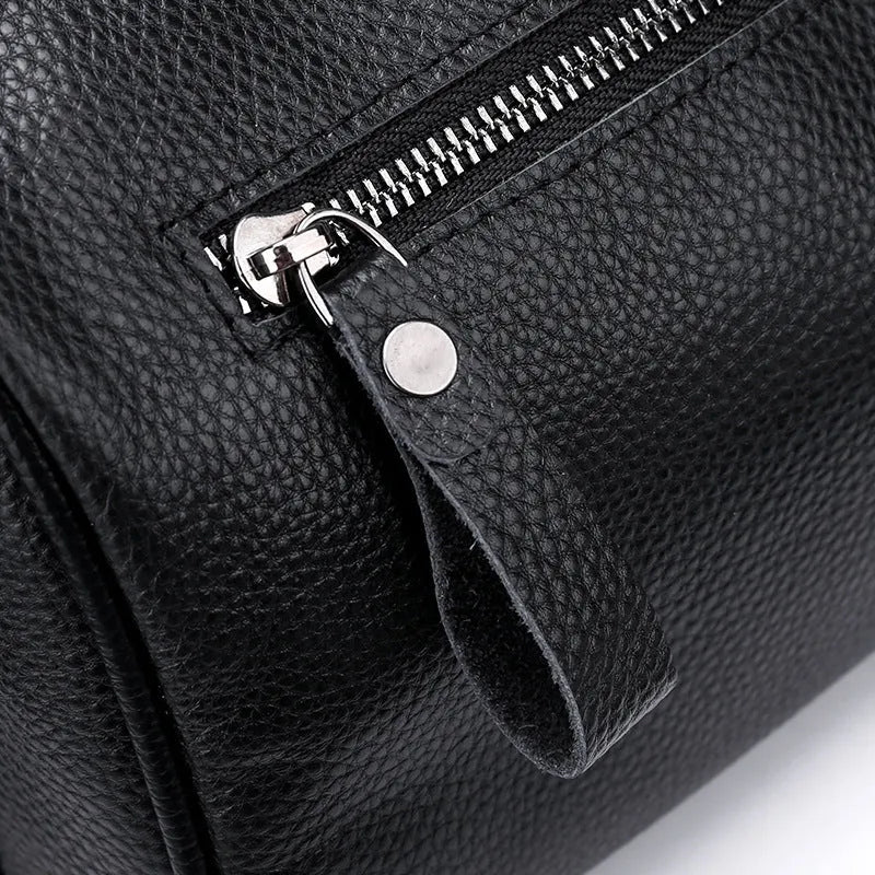 Black genuine leather one-shoulder crossbody bag showing front and side view.