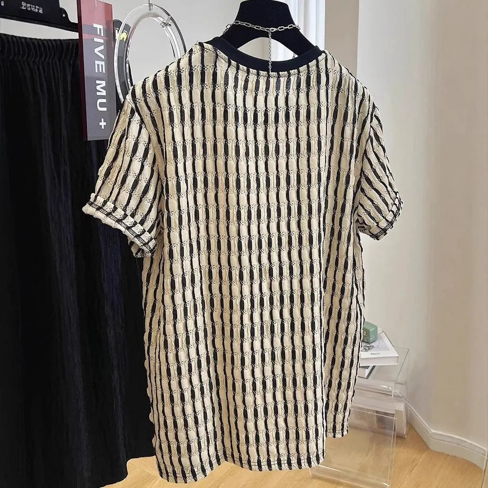 A man's loose-fitting black and white striped casual pullover shirt made from linen and silk.