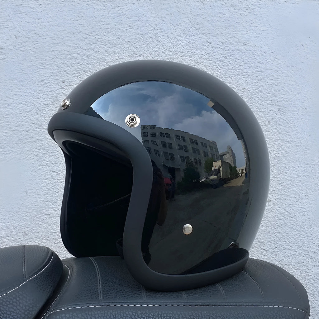 Retro-style half helmet for motorcycles with a fibreglass shell shown in a cement grey colour.