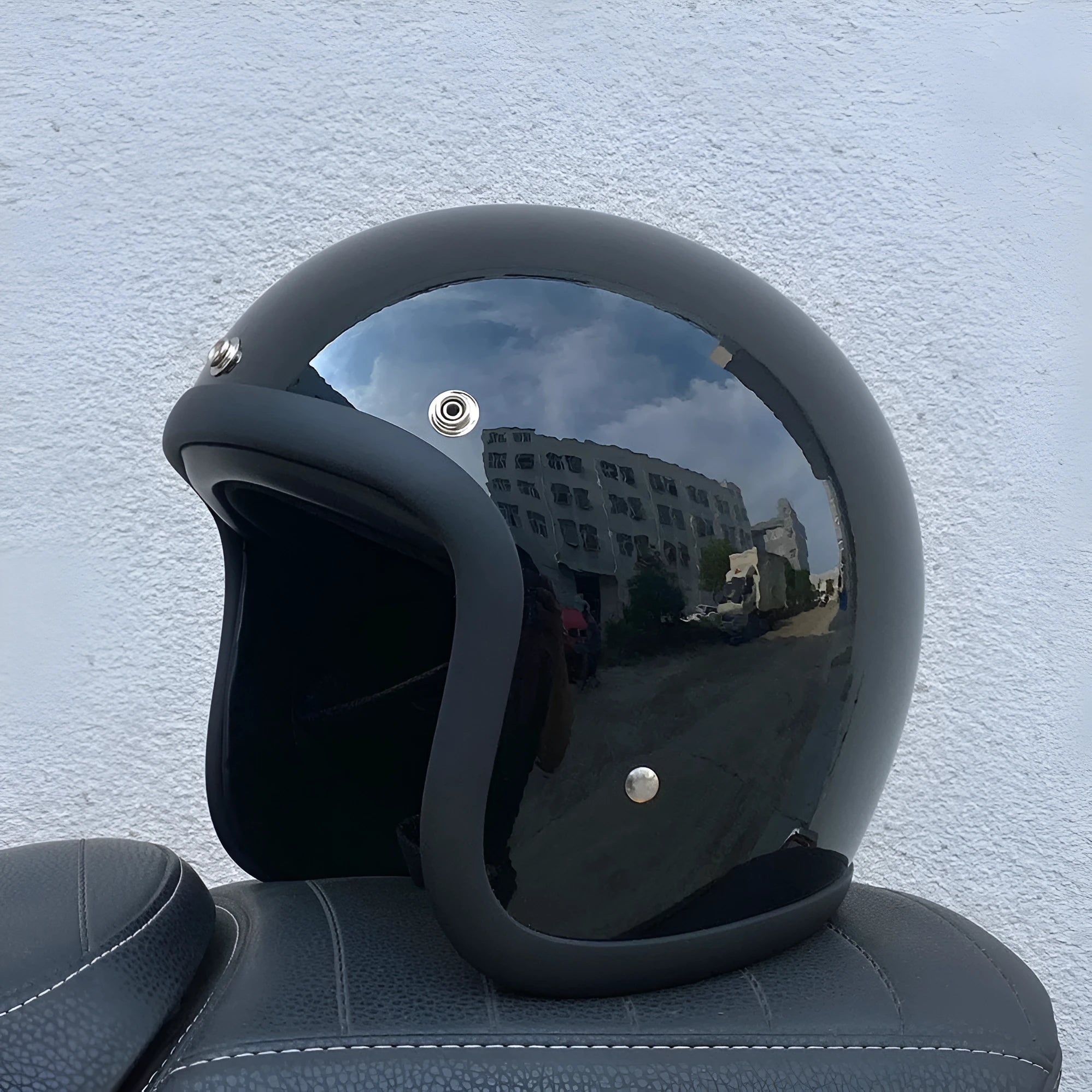 Retro-style half helmet for motorcycles with a fibreglass shell shown in a cement grey colour.