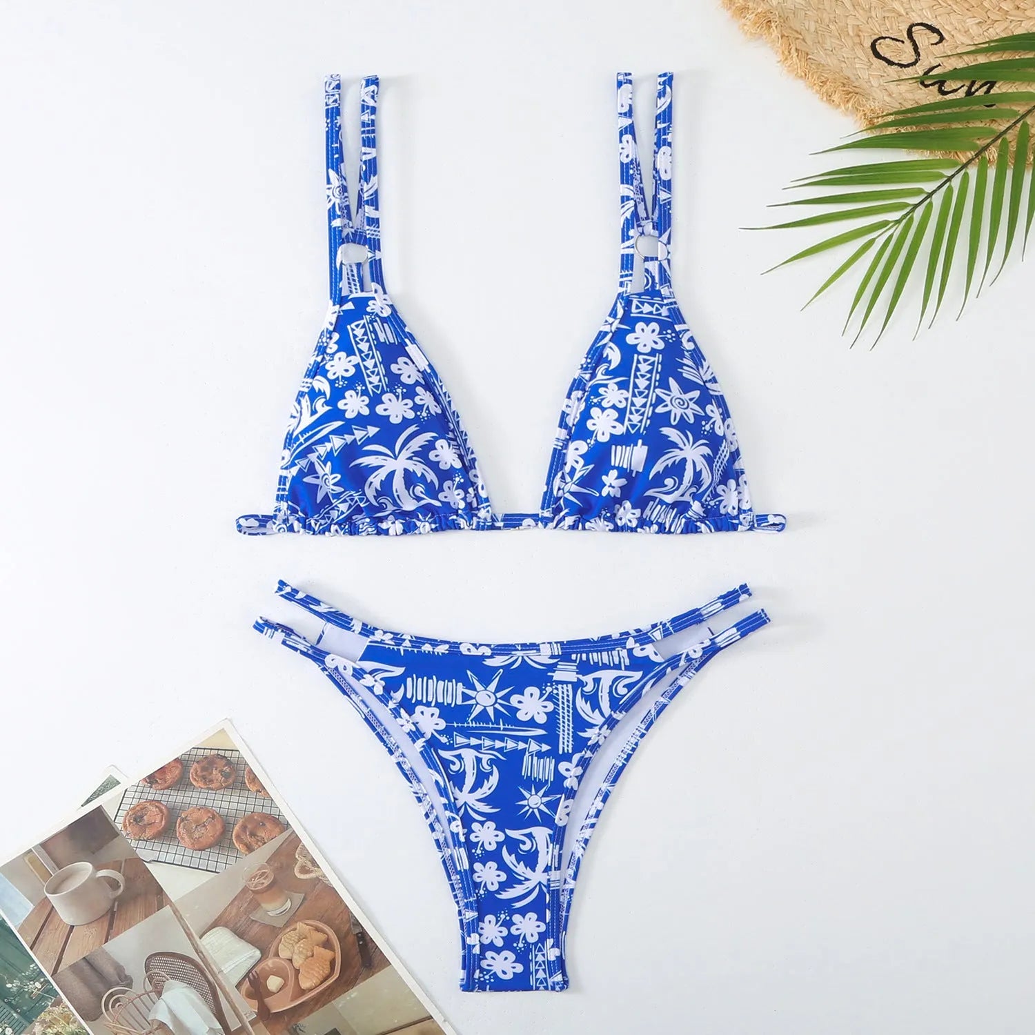 Women's printed halterneck bikini set in blue with floral pattern, showing top and briefs.