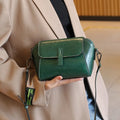 Brown shell-shaped women's messenger bag in soft oil wax leather with a single shoulder strap