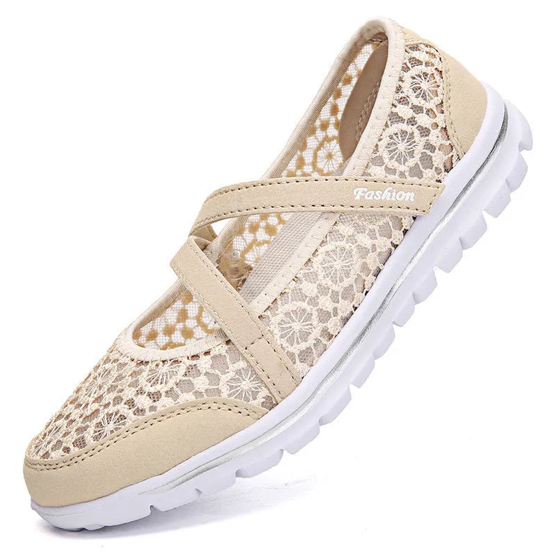 Women's beige lace-up casual flats with mesh upper and round toe on a light background.