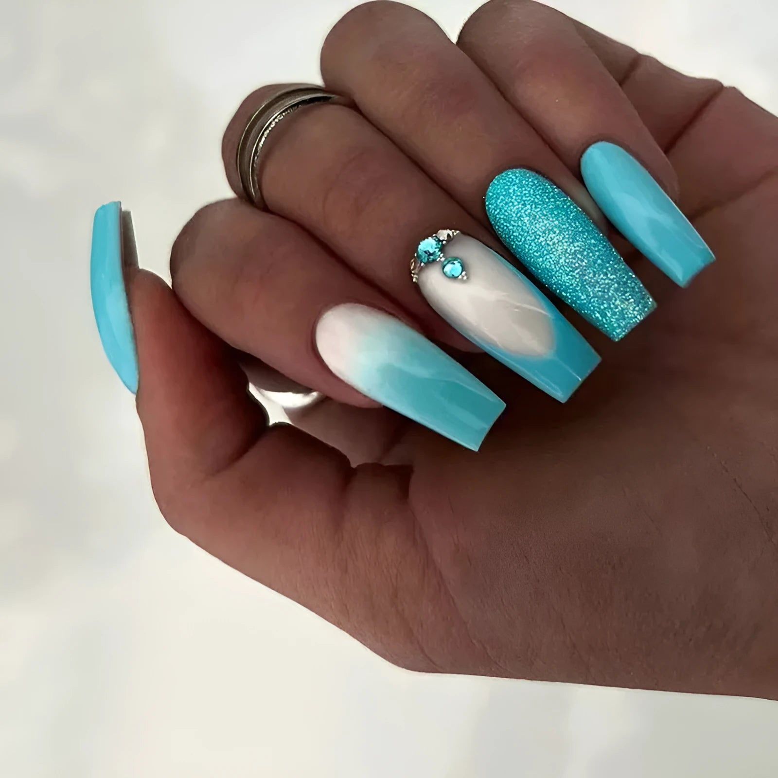 Long ballet nail art patches in smart blue diamond colour with scattered diamond debris detailing
