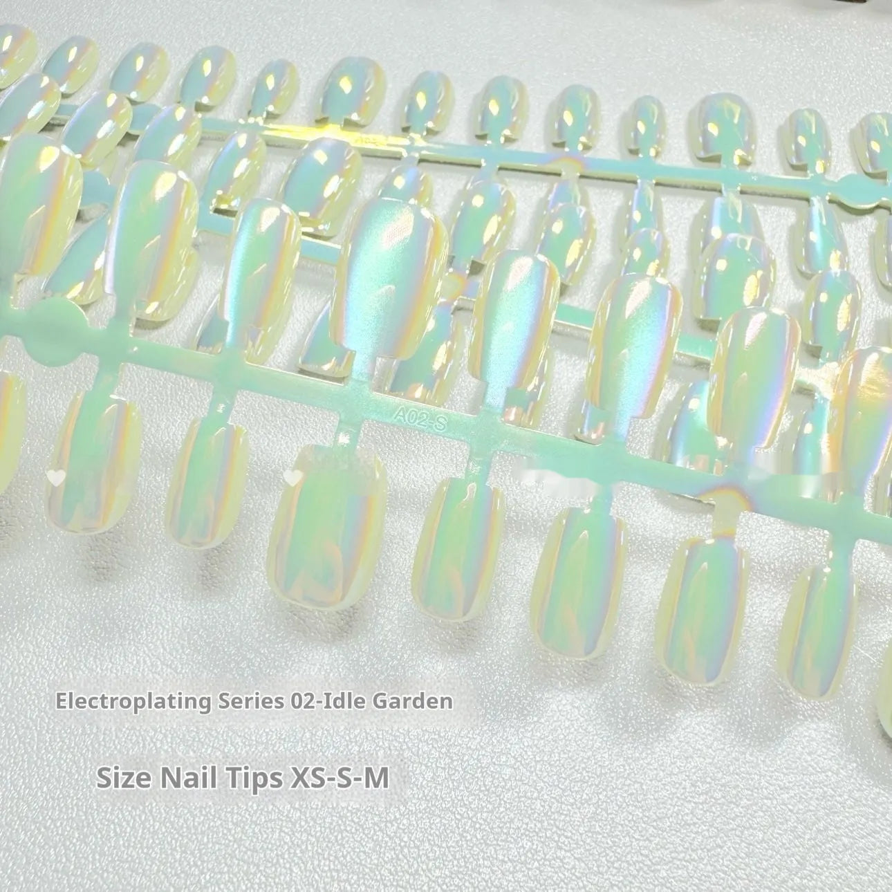 Set of electroplated Cat's Eye false nails in Aurora style showing short ladder shapes in XS, S, and M sizes.