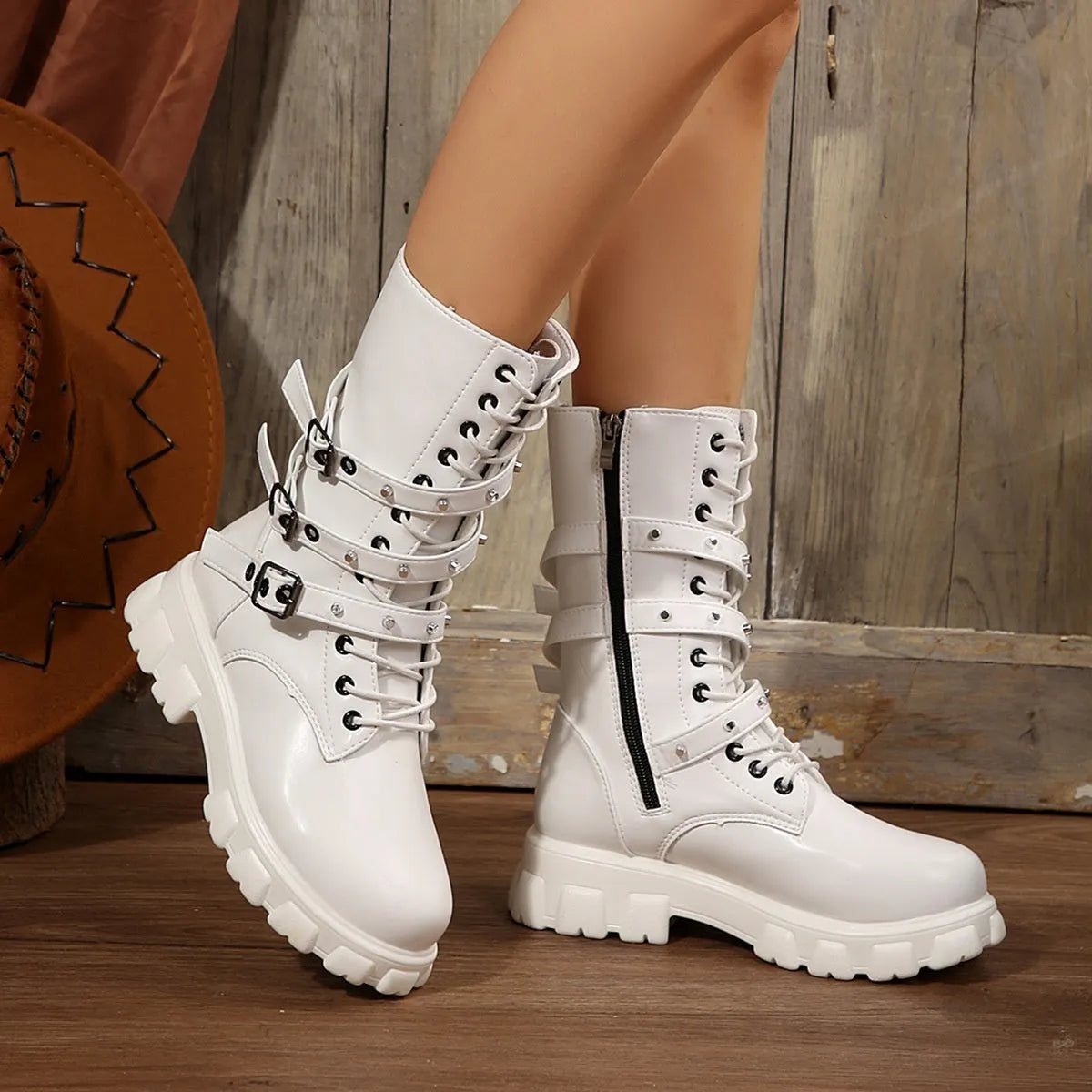 Women's black mid-calf knight boots with a side zip and metal buckle detail on the shaft.